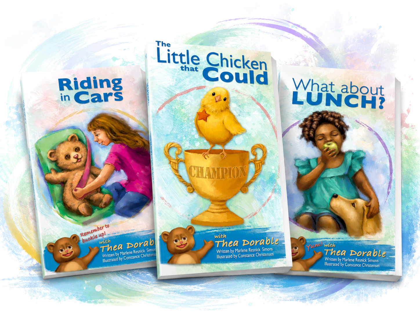 Three colorful children’s book covers displayed in a dynamic, slightly overlapping horizontal arrangement. “Riding in Cars” appears on the left, “The Little Chicken that Could” is centered and featured most prominently, and “What about Lunch?” is on the right, all set against a soft pastel watercolor background with playful brushstroke swirls.