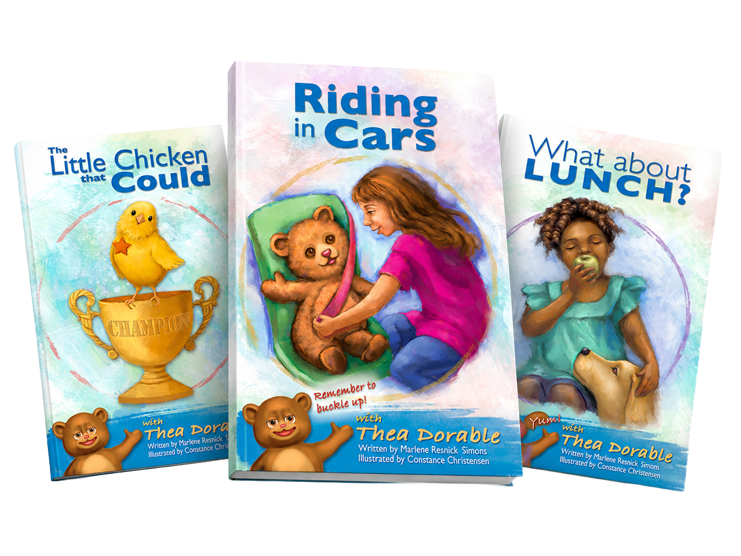 Three colorful children’s book covers displayed in a dynamic, slightly overlapping horizontal arrangement. “Riding in Cars” appears on the left, “The Little Chicken that Could” is centered and featured most prominently, and “What about Lunch?” is on the right, all set against a soft pastel watercolor background with playful brushstroke swirls.