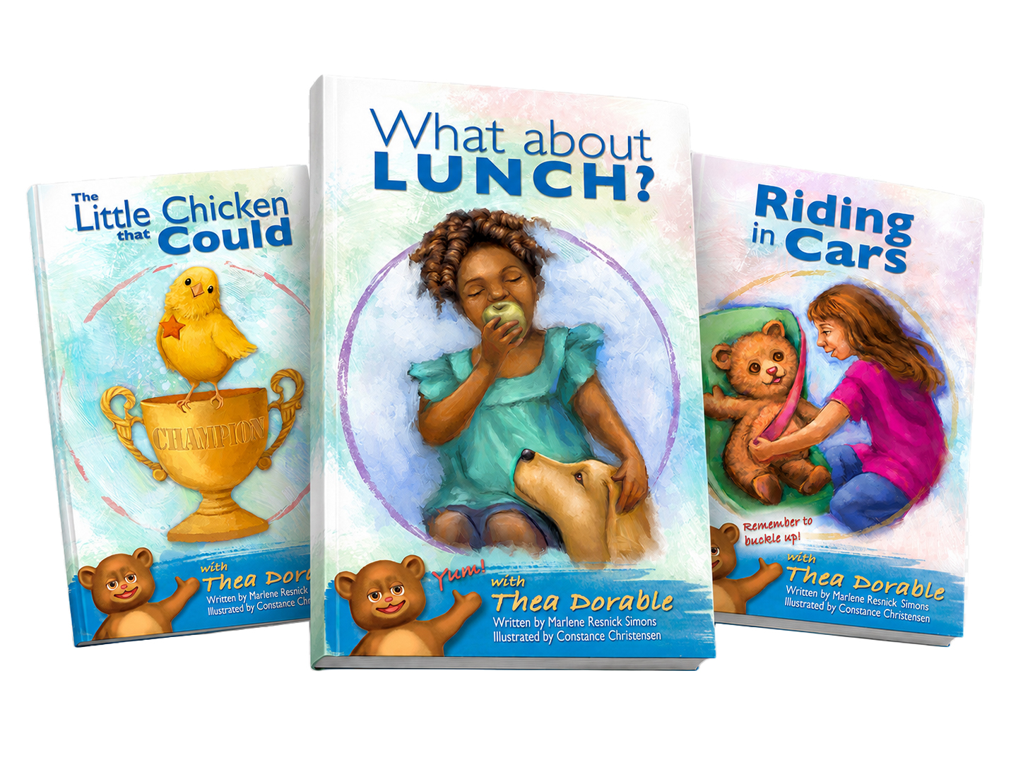 Three colorful children’s book covers displayed in a dynamic, slightly overlapping horizontal arrangement. “Riding in Cars” appears on the left, “The Little Chicken that Could” is centered and featured most prominently, and “What about Lunch?” is on the right, all set against a soft pastel watercolor background with playful brushstroke swirls.